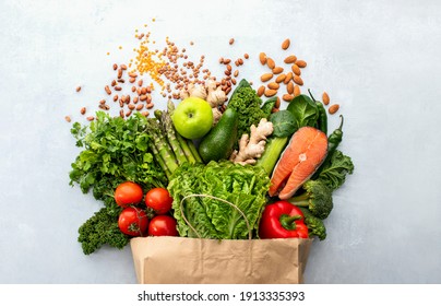Healthy food shopping or delivery concept, top down view on a variety of fresh produce in a paper bag  - Shutterstock ID 1913335393