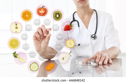 healthy food supplements concept, Hand of nutritionist doctor showing pill on symbols fruits background