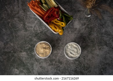 Healthy Food Vegetable Sandwiches Hummus, And Tzatziki In Round Bowl With Red, Green And Yellow Peppers With Carrots And Cucumber. Overhead Photo With Writing Space 