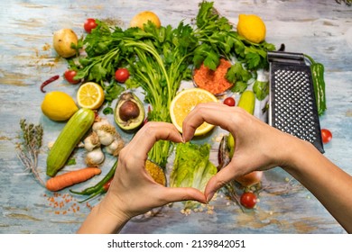 Healthy food with vegetables and fruits. A girl hands making heart sign. Healthy life, diet, loving yourself and balanced nutrition. Background. No people. - Powered by Shutterstock