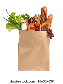 Healthy foods to buy / studio photography of brown grocery bag with fruits, vegetables, bread, bottled beverages - isolated over white background 