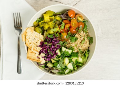 Healthy Fresh Bowl Salad With Spring Mix, Romaine, Quinoa, Cucumber, Tomatoes, Red Cabbage, Dill Pickle, Pita Chips, Parsley, Mint And Dressing