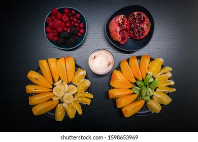 Healthy Fresh Sliced Fruits In Bowl Top View, From Above, Persimmon, Pomegranate, Kiwi, Oranges, Bananas, Cranberries, Blackberries, Rasberries