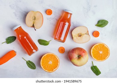 Healthy Fruit Juices, Apples And Oranges On White Table, Top View. Superfoods And Healthy Lifestyle Or Detox Diet Food Concept.