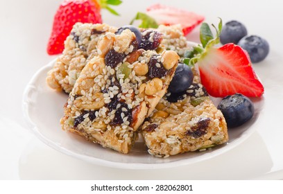 Healthy Fruit And Nut Granola Bars On White Plate.