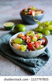 Healthy Fruit Salad With Quinoa, Strawberry, Peach, White Grapes, Plums, Mint And Honey Lime Dressing