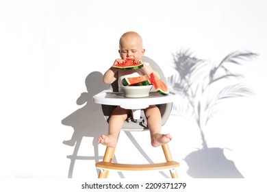 Healthy Fruit Snack. Cute Baby, Child, Kid Emotins. Toddler Boy In Feeding Chair Eats Watermelon, Isolated On White Background. Vegan Healthy Diet, Feeding, Solid Food Concept. Copy Space.