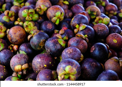 Healthy fruits Red mangosteen background, dark mangosteen, dark mangosteen in a supermarket local market bunch of mangosteen ready to eat
