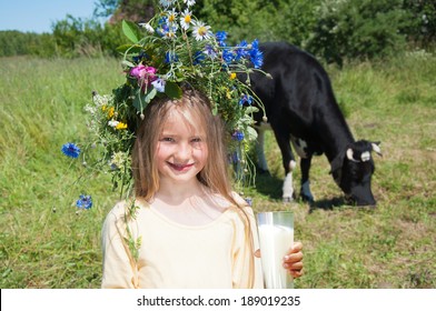 Healthy girl drinking fresh milk outdoors