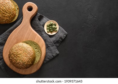 Healthy Gluten Free Spirulina Fresh Bud For Vegan Burger On Dark Black Background With Copy Space. View From Above.