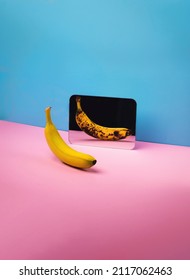 Healthy good looking banana with spoiled unhealthy reflection in the mirror, on a pink and blue background. Inside and outside feelings concept.