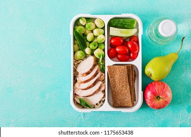 Healthy Green Meal Prep Containers With Chicken Fillet, Rice, Brussels Sprouts And Vegetables Overhead Shot With Copy Space. Dinner In Lunch Box. Top View. Flat Lay