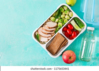 Healthy Green Meal Prep Containers With Chicken Fillet, Rice, Brussels Sprouts And Vegetables Overhead Shot With Copy Space. Dinner In Lunch Box. Top View. Flat Lay