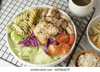 Healthy Green Salad With Chicken Breas, Fusilli Pasta, Tuna Mayo, Tomatoes, With Boiled Egg With Sesame Dressing And Olive Dressing Isolated On White Background