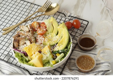 Healthy Green Salad With Chicken Breas, Fusilli Pasta, Tuna Mayo, Tomatoes, With Boiled Egg With Sesame Dressing And Olive Dressing Isolated On White Background