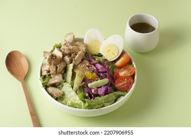 Healthy Green Salad With Chicken Breas, Fusilli Pasta, Tuna Mayo Isolated On Green Background