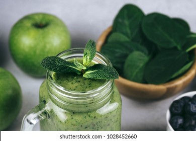 Healthy Green Smoothie In A Glass Jar And Ingredients On White - Spinach, Apple And Blueberry. Superfood, Detox Food