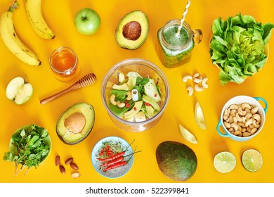 Healthy green smoothie ingredients: avocado, green salad, banana, mint leaves, cashew nuts, chilli and lime, apple, chia sprouts, goji berry and honey.  - Powered by Shutterstock