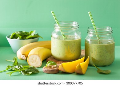 Healthy Green Smoothie With Spinach Mango Banana In Glass Jars