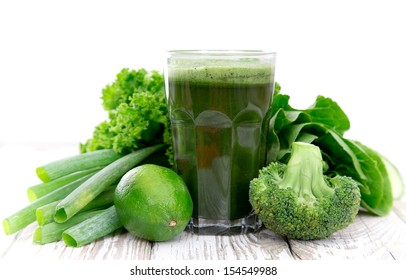 Healthy Green Vegetable Juice On Wooden Table