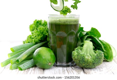 Healthy Green Vegetable Juice On Wooden Table