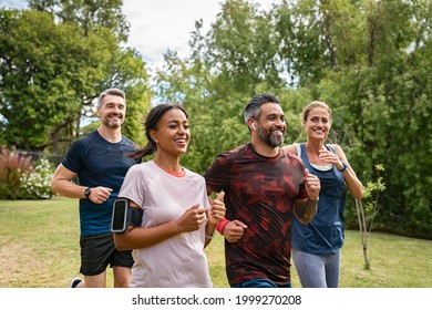 Healthy group multiethnic middle aged men   women jogging at park  Happy mixed race couples running together  Mature friends running together outdoor 