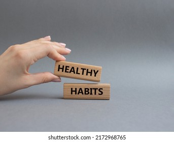 Healthy habits symbol. Concept word Healthy habits on wooden blocks. Beautiful grey background. Businessman hand. Business and Healthy habits concept. Copy space - Shutterstock ID 2172968765