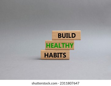 Healthy habits symbol. Concept word Build Healthy habits on wooden blocks. Beautiful grey background. Healthy lifestyle and Healthy habits concept. Copy space - Shutterstock ID 2311807647