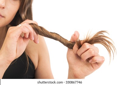 Healthy Hair Growth Concept. Portrait Of Beautiful Young Woman Holding Her Long Hair On White Background