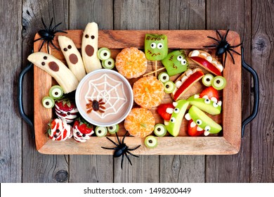 Healthy Halloween Fruit Snacks. Tray Of Fun, Spooky Treats. Top View Over A Rustic Wood Background.