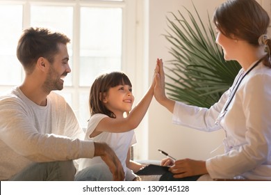 Healthy happy child girl giving high five to female caring doctor celebrate good checkup medical result recovery visiting pediatrist in hospital, pediatrician with kid patient good relationship trust