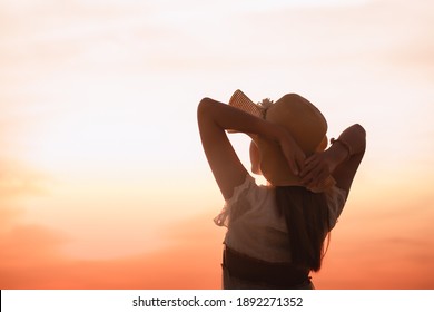 Healthy and happy woman raising her hands on blurry background. Style
concept of freedom
