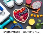 Healthy heart  diet and sport gym equipment concept on blackboard
