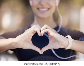 Healthy, heart hands or happy girl runner in park for fitness, exercise or workout for cardiovascular health. Love sign, hand gesture or blurry sports woman in sports training for wellness in nature