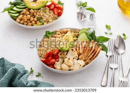 Healthy high protein lunch bowl with grilled chicken, roasted cauliflower, herbed chickpeas and quinoa
