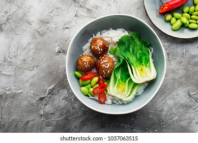 Healthy home cooking. Meat balls teriyaki, rice, cabbage bok choy bowl with sesame seeds in a ceramic dish. Top View