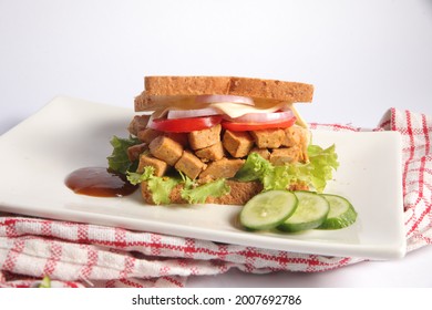 healthy home made chicken tikka sandwich with fresh vegetables on a white plate table top food photography