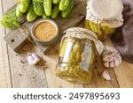 Healthy homemade fermented food. Salted pickled cucumbers with mustard preserved canned in glass jar. Home economics, autumn harvest preservation. 