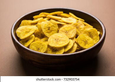 Healthy Homemade Kela or Banana chips or wafers served over moody background, selective focus

