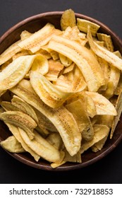 Healthy Homemade Kela or Banana chips or wafers served over moody background, selective focus