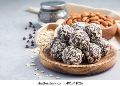 Healthy homemade paleo chocolate energy balls with rolled oats, nuts, dates and chia seeds, horizontal, copy space