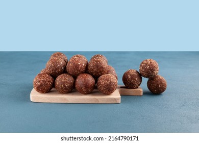 Healthy Homemade Sweets On Wooden Cutting Board. Energy Balls Are A Healthy Snack. Balls Of Ground Dried Fruit And Nuts.