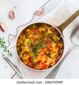 Healthy Homemade Vegan Food Concept. Stew Organic Vegetables Ragout French Ratatouille In Stewpan On A White Cozy Kitchen Table. Top View Flat Lay Background