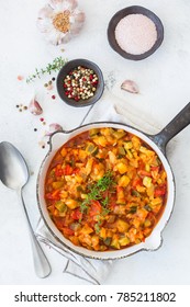 Healthy Homemade Vegan Food Concept. Stew Organic Vegetables Ragout French Ratatouille In Frying Pan On A White Cozy Kitchen Table. Top View Flat Lay Background