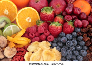Healthy immune system boosting fruit superfood background with fruits high in antioxidants, vitamin c, minerals, anthocyanins & dietary fibre.   Flat lay, top view.