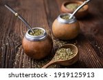 Healthy infused drink, classic Yerba Mate tea in a gourd with bombilla on wooden background