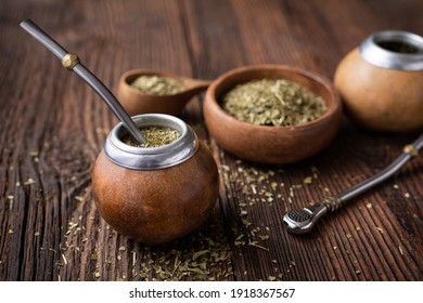 Healthy infused drink, classic Yerba Mate tea in a gourd with mobilla on wooden background