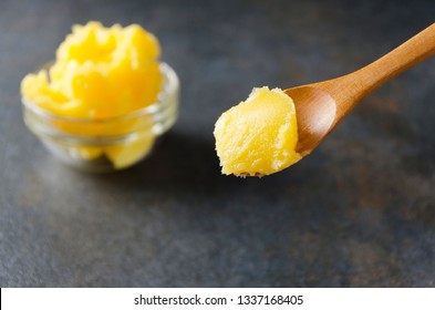Healthy ingredient for cooking organic meal.Spoon with ghee or clarified butter,closeup