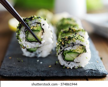 Healthy Kale And Avocado Sushi Roll With Chopsticks