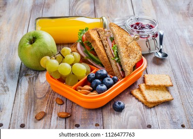 Healthy Kids Lunchbox With Sandwich, Fruits And Orange Juice